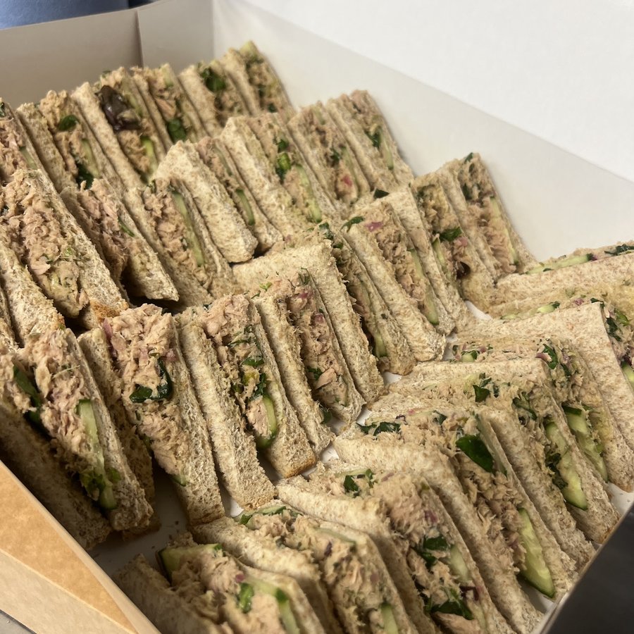 A catering tray of cut tuna sandwiches from PadamPadam.